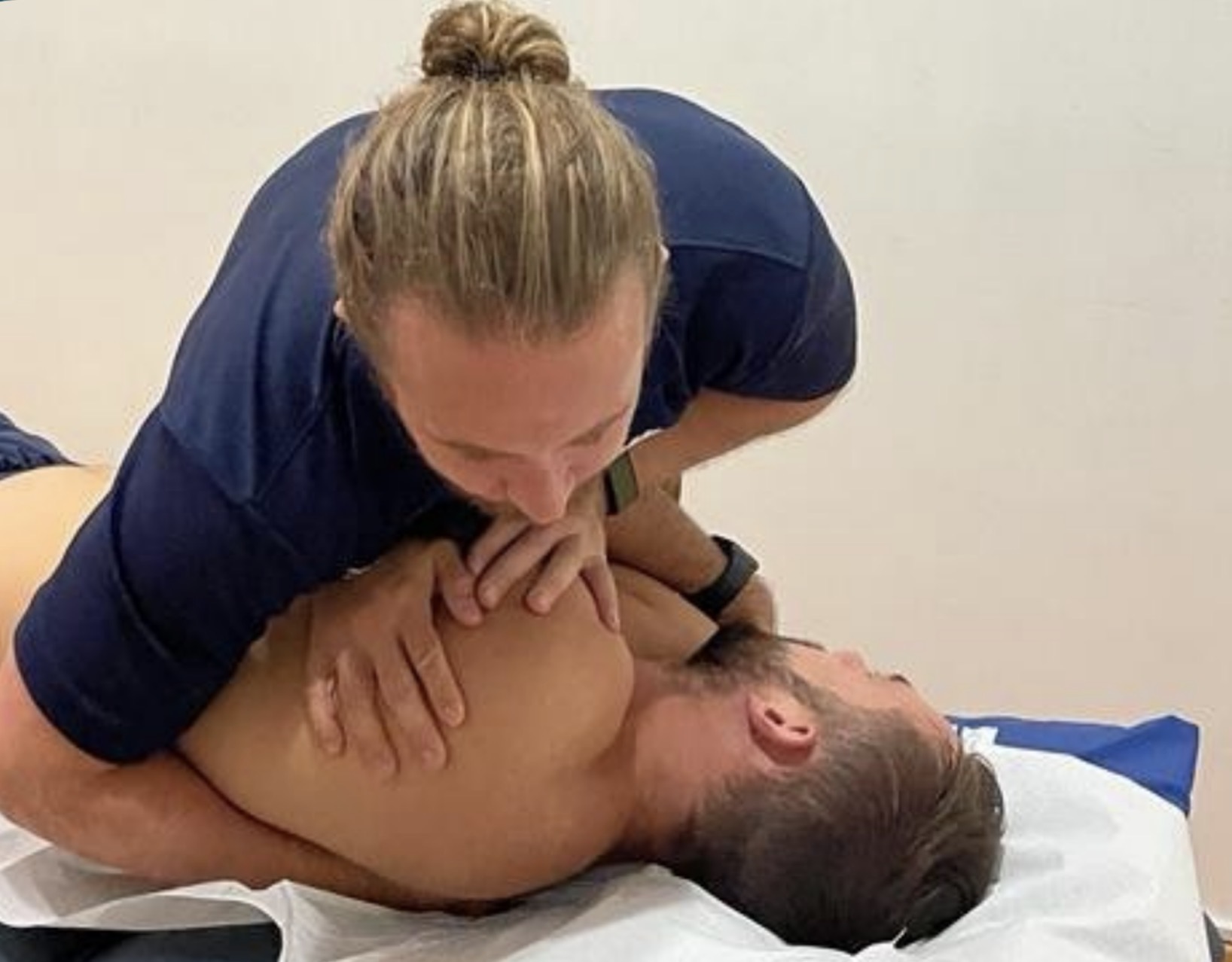 Siôn delivering hands-on treatment to a patient